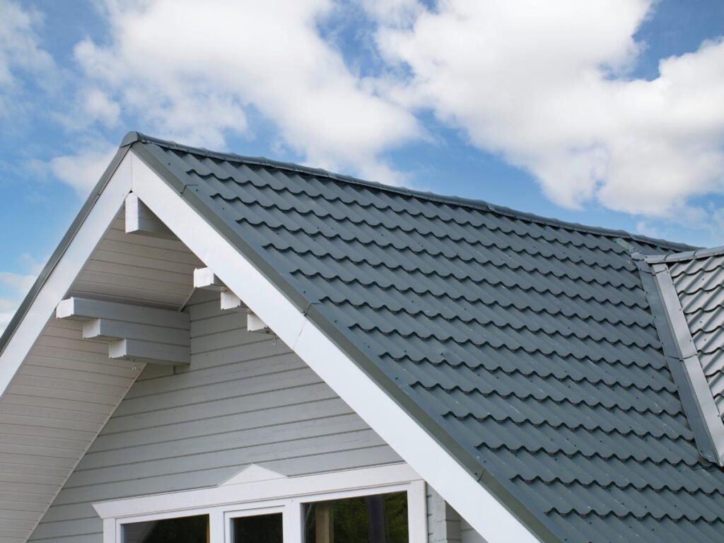 Metal roofer in Lebanon, TN installing a matte black standing seam roof