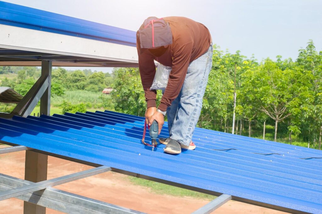 Metal roofer near me in Kingston Springs, TN finishing a custom standing seam roof
