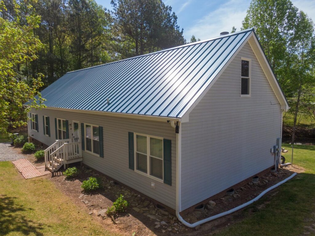 Metal roofer near me in Lebanon, TN working on a farmhouse roof replacement